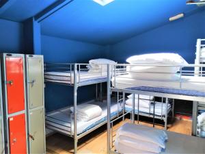 a room with two bunk beds and a desk at The Phoenix Hostel in London