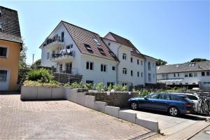 a car parked in a parking lot next to a building at Ostseeblick-Laue-Wohnung-8-H in Hohwacht