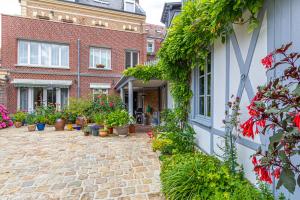 a courtyard of a house with potted plants at Maison Longuevie in Amiens