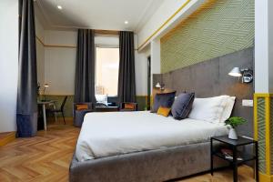 Postel nebo postele na pokoji v ubytování Roma Five Suites