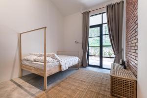 a bedroom with a bed and a large window at The Rubber Escape, Melaka in Malacca +89 photos