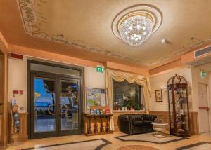 a living room with a ceiling with a chandelier at Grande Albergo in Sestri Levante