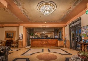 a lobby with a reception desk and a chandelier at Grande Albergo in Sestri Levante +37 photos