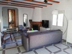 a living room with a couch and a tv at Adel Locdenia in Els Poblets