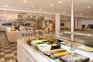a buffet line with food on display in a restaurant at HSM Canarios Park in Calas de Mallorca