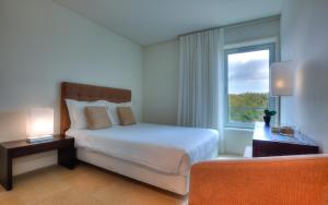 a hotel room with a bed and a window at Troia Residence by The Editory - Apartamentos Marina in Troia