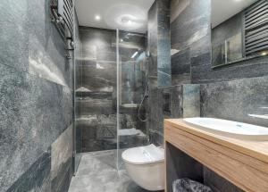 a bathroom with a toilet and a sink and a shower at Studio Mini Moris - ACCO RENT in Sopot