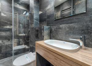 a bathroom with a sink and a shower at Studio Mini Moris - ACCO RENT in Sopot
