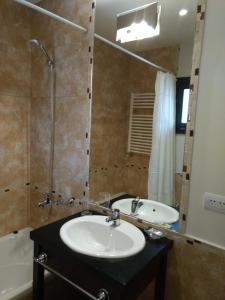 a bathroom with a sink and a shower and a tub at Departamentos - Belgrano 810 in San Martín de los Andes