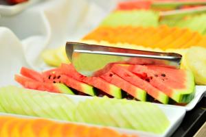 a plate of watermelon and other fruit on a buffet at Savoy Hotel Encarnación in Encarnación