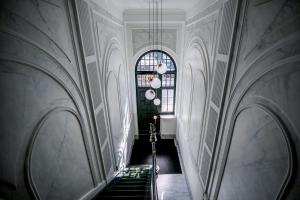 an empty hallway with stairs and a window at B&B Boutique Hotel N10 in Roermond