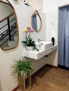 a bathroom with a sink and a mirror at Khoảng Lặng ATP in Da Lat