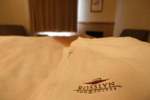 A bed or beds in a room at Rosslyn Inn & Suites