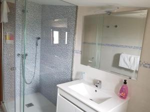 a bathroom with a shower and a sink and a shower at Hostería Carmen in Santillana del Mar