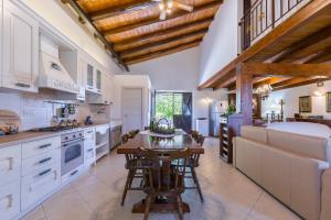 a kitchen with white cabinets and a wooden ceiling at Vdl Country Villa in Floridia