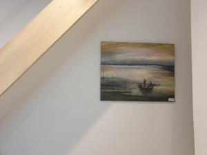 a painting of a boat on the water at Hai Hotel in Larnaca