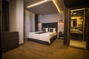 a bedroom with a large bed and a bathroom at International Palace in Veles