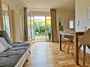 a living room with a couch and a table at Allgäu Apartment Kempten in Kempten