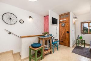 a living room with a table and chairs and a wall at House Pavincic in Lovran