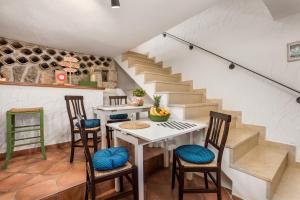 a room with a table and chairs and stairs at House Pavincic in Lovran