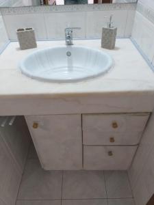 a bathroom sink with a white counter top at Tavira sweet home in Tavira +68 photos