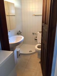 a bathroom with a sink and a toilet and a sink at Villa Valia: Traditional Luxurious Residence in Pyrgadikia