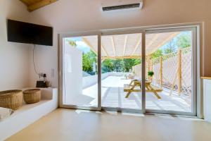 a living room with a sliding glass door leading to a patio at Casa do Chico in Olhão