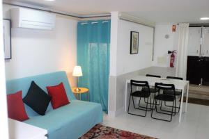 a living room with a blue couch and a table at Alfama 34 in Lisbon