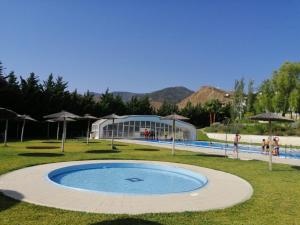 a large swimming pool with a building in the background at La casa del viajero in Ardales