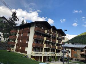 a large apartment building with balconies on it at Blomatu II Top Floor in Saas-Fee