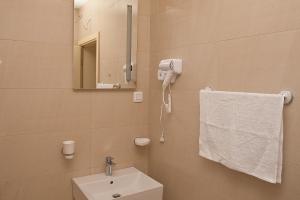 a bathroom with a sink and a mirror and a towel at Mariner 602 in Sutomore