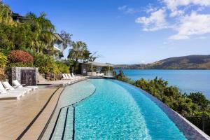 a swimming pool with a view of the water at Shorelines 23 On Hamilton Island in Hamilton Island