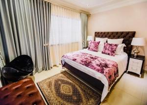 a bedroom with a large bed and a window at 7 Yellow Wood Drive, Zimbali Coastal Estate in Ballito +40 photos