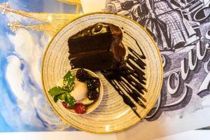 a piece of chocolate cake and berries on a plate at The Mews Hotel in Wakefield
