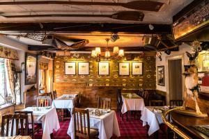 a dining room with tables and chairs in a restaurant at The Mews Hotel in Wakefield