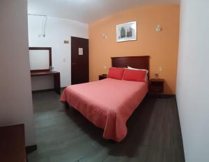 En eller flere senge i et værelse på Hotel La Finca