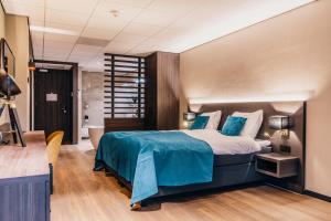 Postel nebo postele na pokoji v ubytování Hotel Hoogeveen