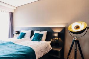 Postel nebo postele na pokoji v ubytování Hotel Hoogeveen