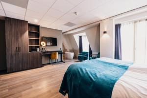 Postel nebo postele na pokoji v ubytování Hotel Hoogeveen