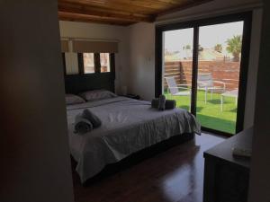 a bedroom with a bed and a view of a yard at Town centre suites in Larnaka
