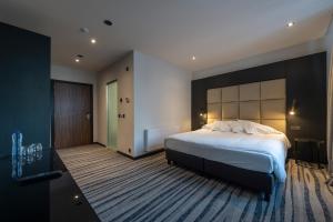 Postel nebo postele na pokoji v ubytování Hotel Monarc