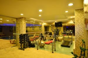 a gym with cardio equipment in a room at Ottoman Village in Alanya