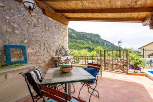 a patio with a table and chairs on a balcony at House Pavincic in Lovran