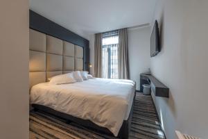 Postel nebo postele na pokoji v ubytování Hotel Monarc