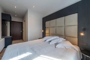 Postel nebo postele na pokoji v ubytování Hotel Monarc
