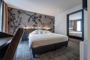 Postel nebo postele na pokoji v ubytování Hotel Monarc