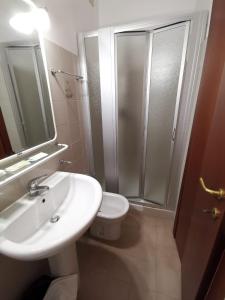 a bathroom with a sink and a toilet and a shower at Hotel Calgary in Casalbordino