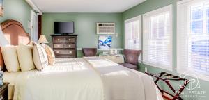 a bedroom with a large bed and green walls at Bouchard Restaurant & Inn in Newport