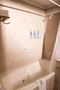a bathroom with a bath tub in a room at Mayflower Suites in Buenos Aires