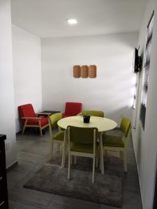 a dining room with a table and chairs at Bij BRAKKE in Paramaribo